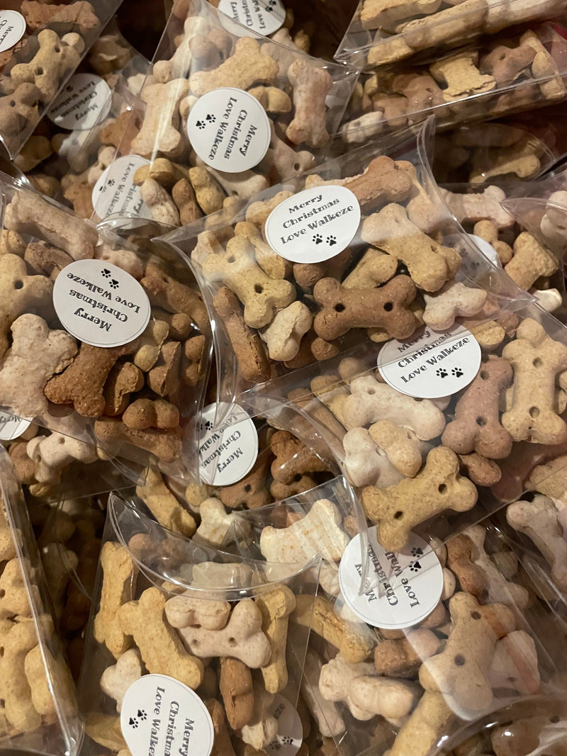 Packaged dog treats shaped like bones with visible brand name on labels.