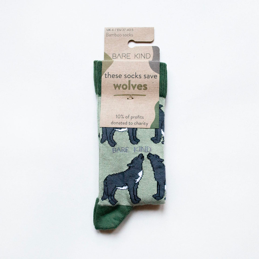 Green sock with wolf design and Bare Kind packaging on a white background