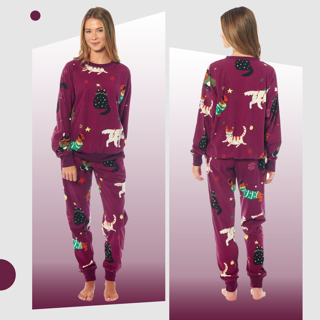 Purple pajama set with cat pattern worn by a model on a white background